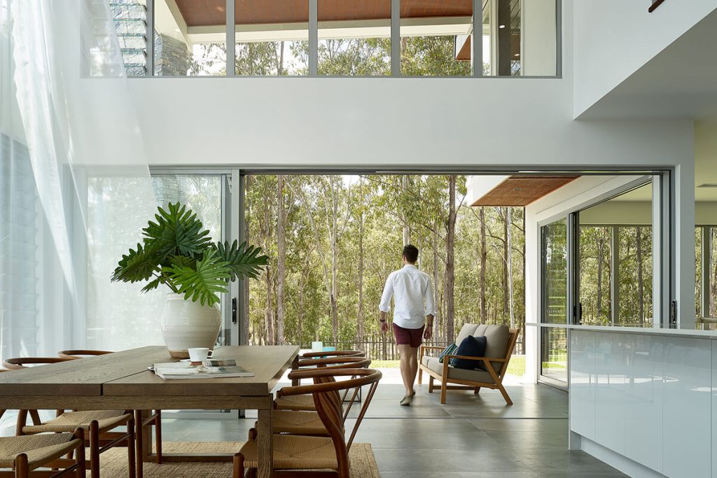 A man walking in his home.